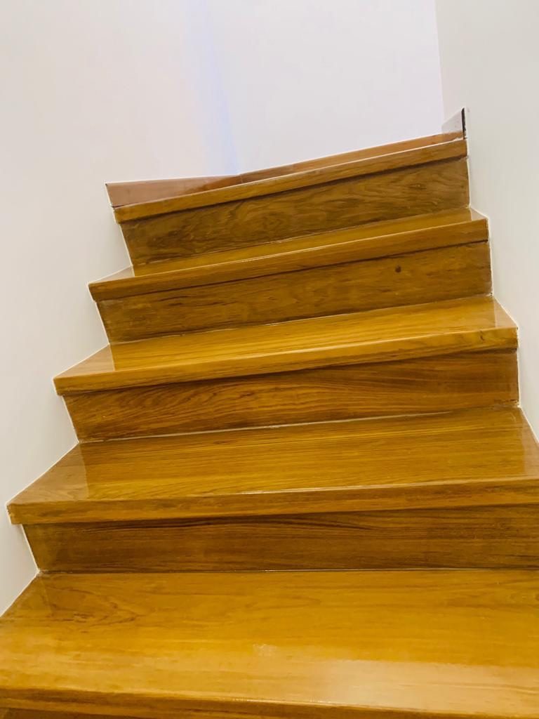 Close-up of an installed strip parquet floor in a Singapore room showing colour and grain variation between strips